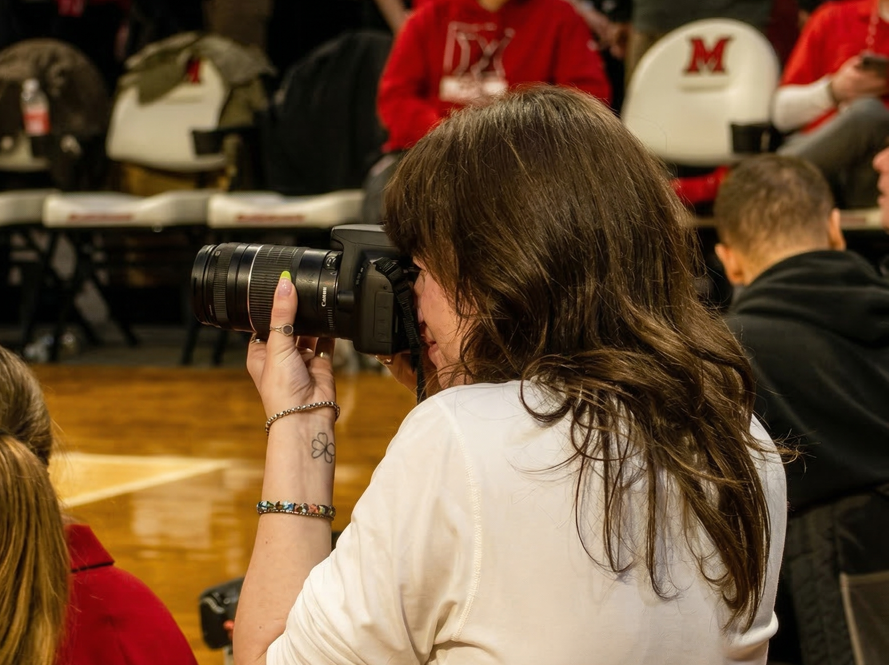 Ivy Kleinman shooting courtside at a Miami University basketball game